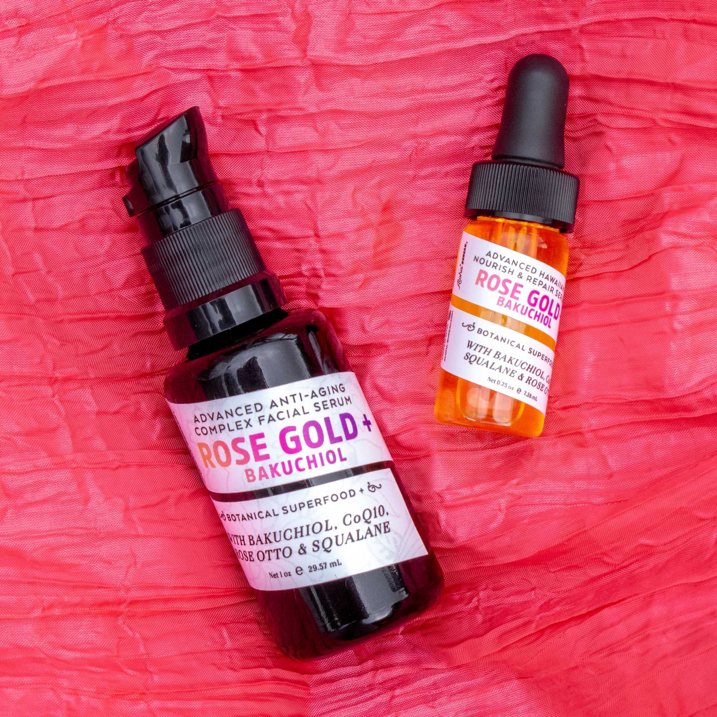 Rose Gold + Bakuchiol 1oz and 0.25 oz serum bottle bright pink satin background